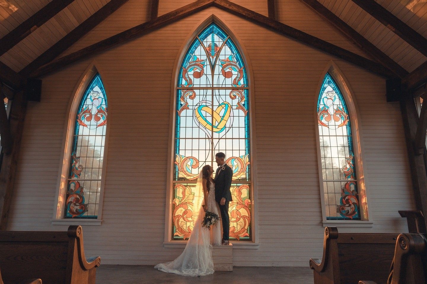 wedding in church with painted windows