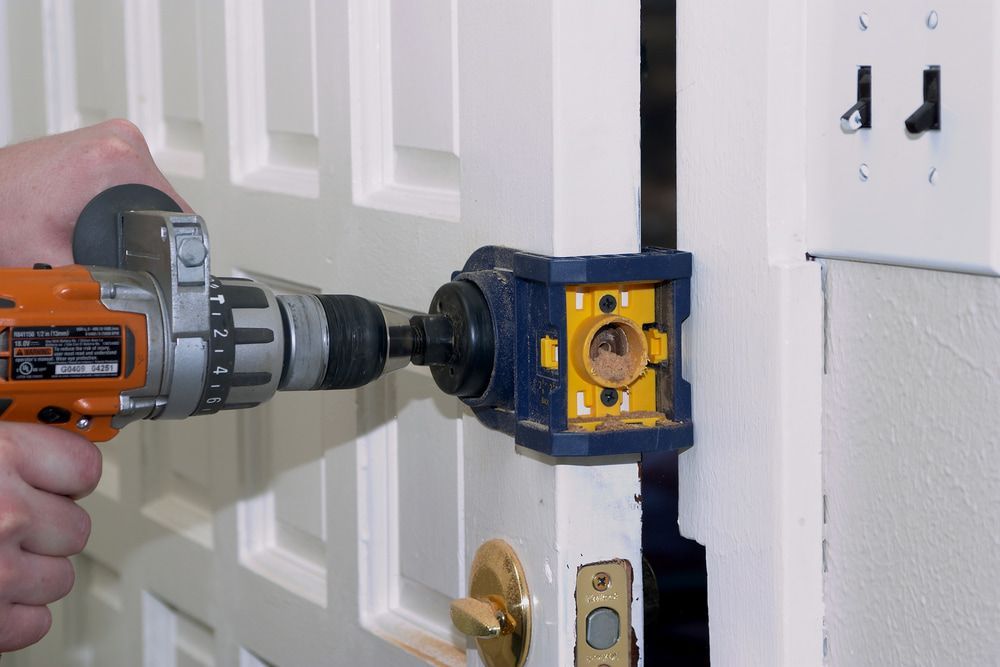 A Person Is Using a Drill to Fix a Door Lock — The Lock Doctor in Mount Hutton, NSW