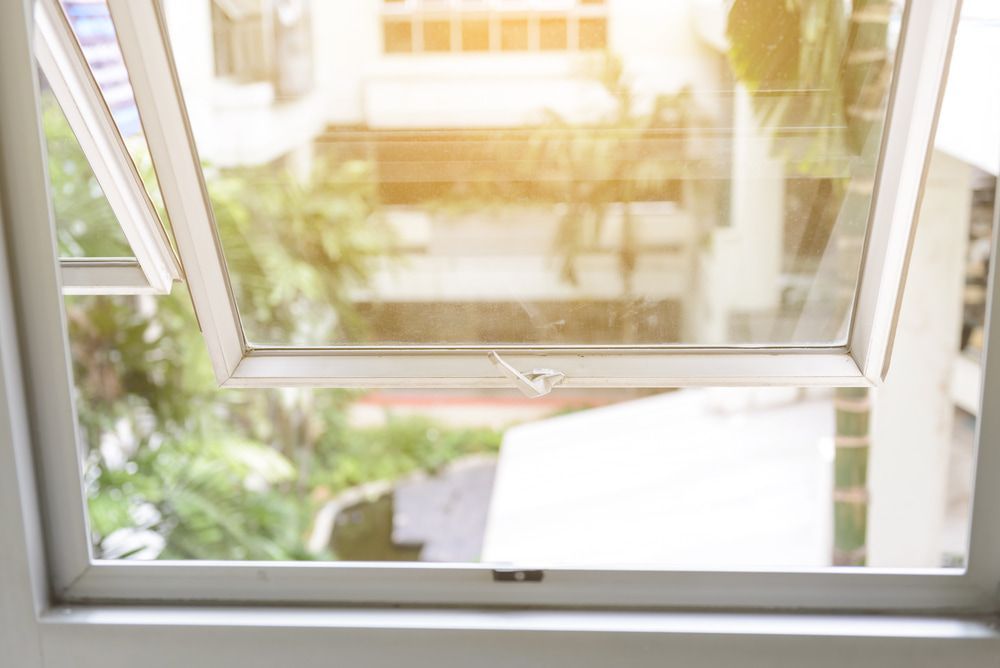 A Close up Of an Open Window with A View of A House — The Lock Doctor in Mount Hutton, NSW