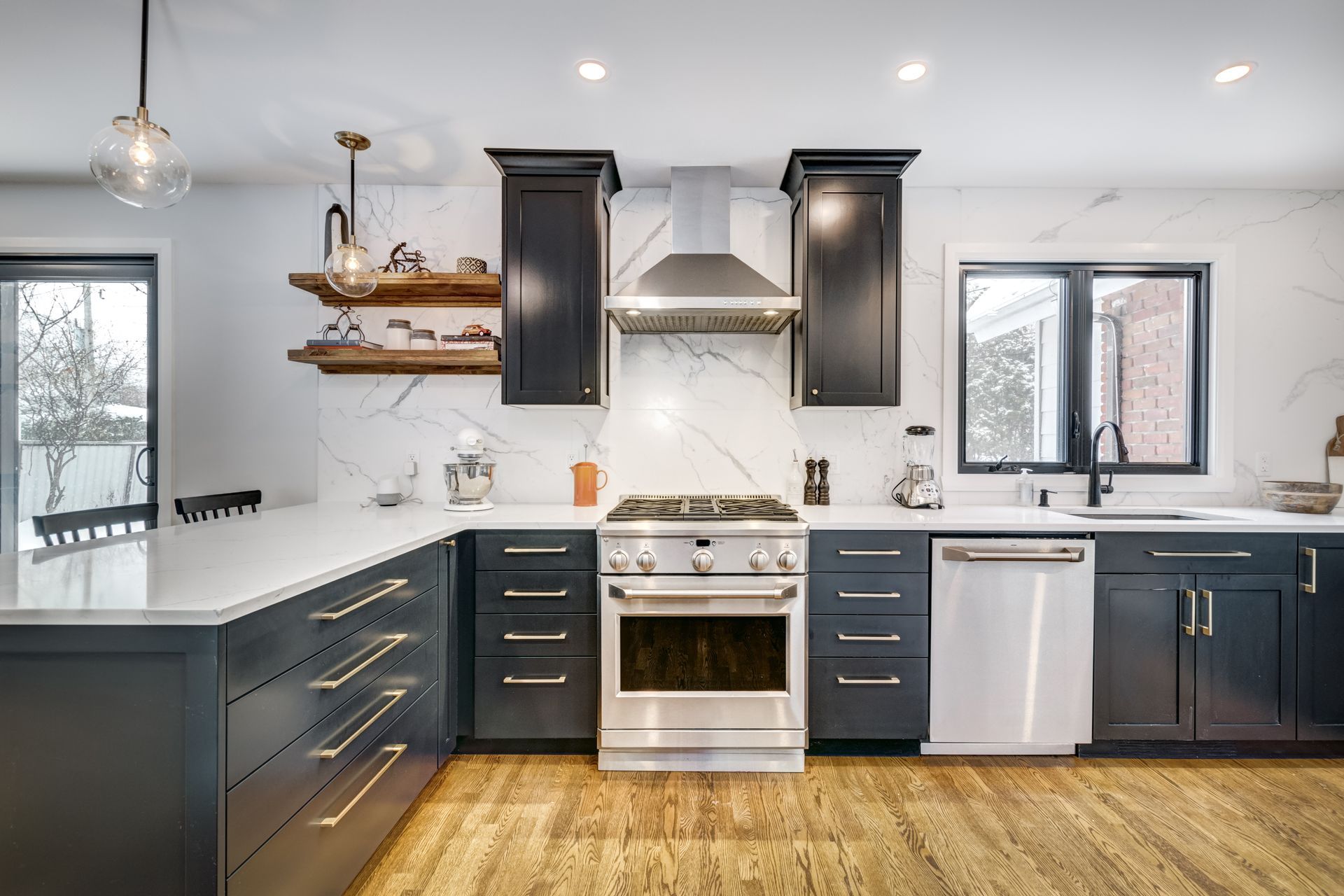 a kitchen with stainless steel appliances and black cabinets