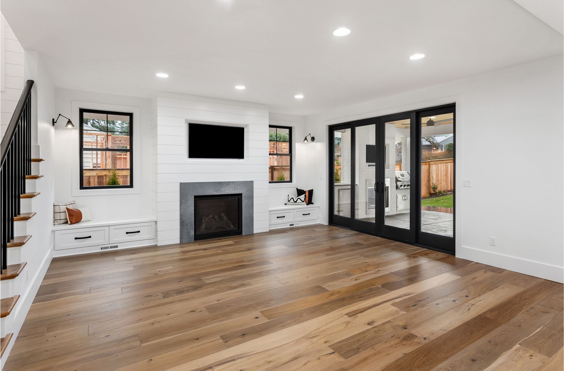 a living room with hardwood floors and a fireplace