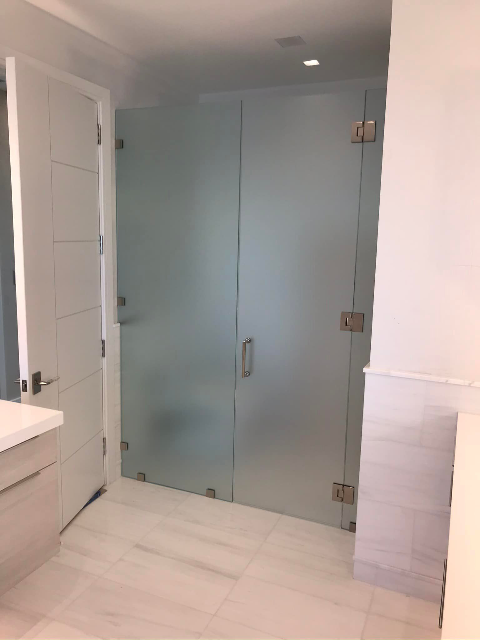 A Bathroom With a Glass Shower Door and a Sink — Horsham, PA — Affordable Custom Enclosures, Inc.
