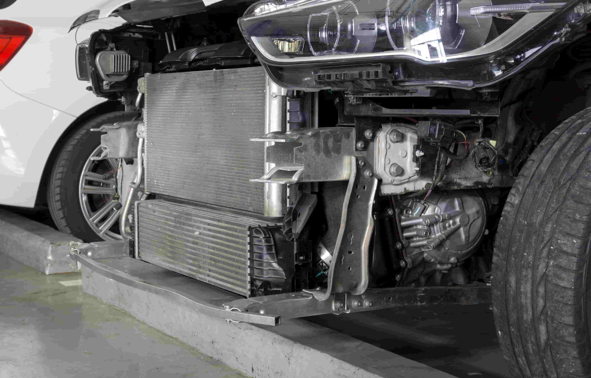the Front End of a Car is Being Removed in a Garage. — FSK Paint & Panel in Casino, NSW 