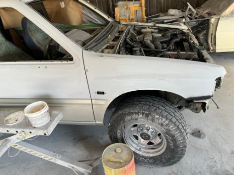 a White Truck With the Hood Up is Sitting in a Garage. — FSK Paint & Panel in Casino, NSW