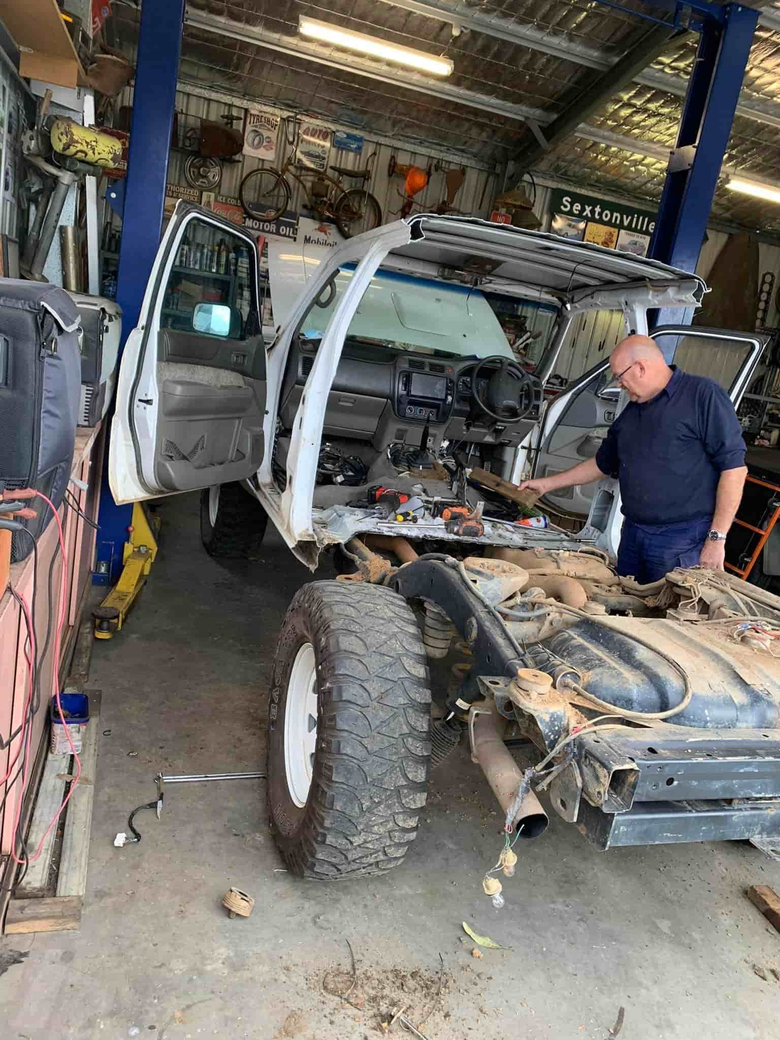 a Man is Working on a Truck in a Garage. — FSK Paint & Panel in Casino, NSW