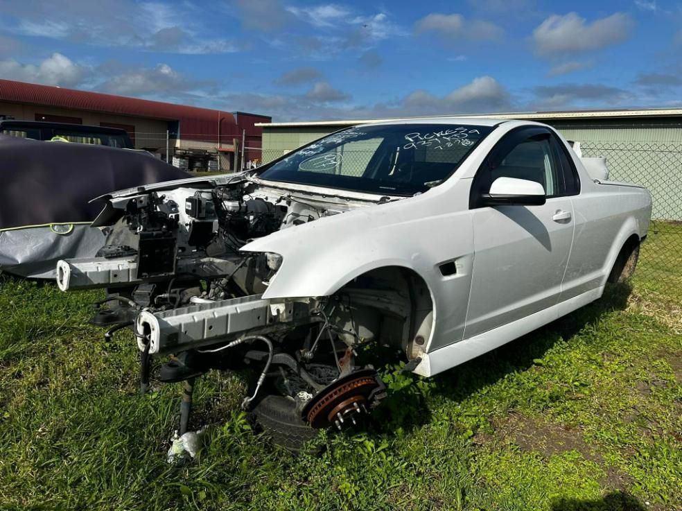 a White Pickup Truck is Sitting in a Grassy Field. — FSK Paint & Panel in Casino, NSW