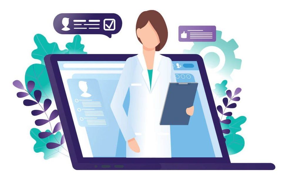 A female doctor is standing in front of a laptop computer holding a clipboard.