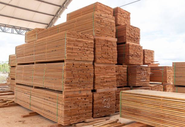 Stacked lumber products wrapped in plastic, ready for shipping or construction use.
