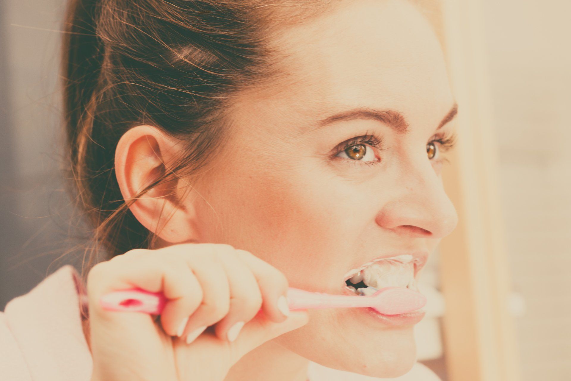 Woman Brushing Her Teeth — Statesville, NC — Joseph M. Perry, D.D.S., P.A.