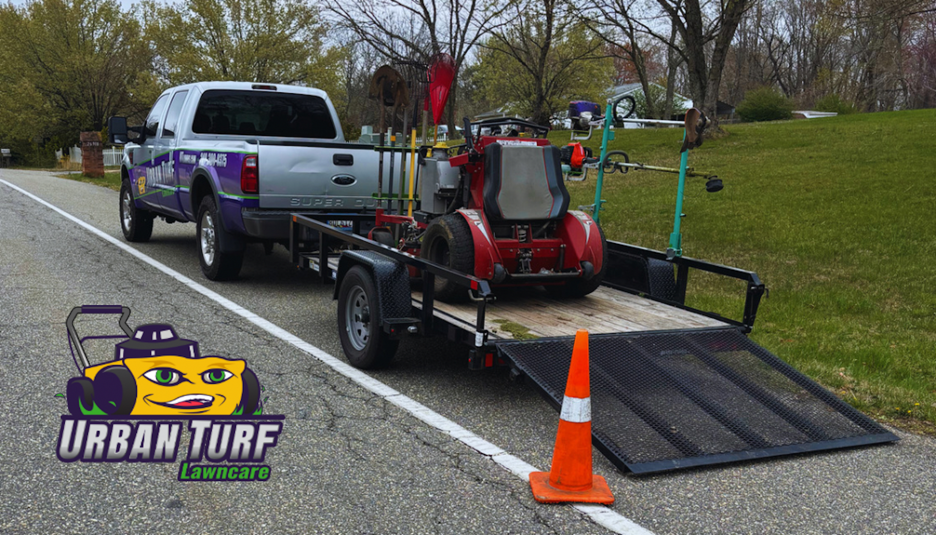 A truck is towing a trailer with a lawn mower on it.