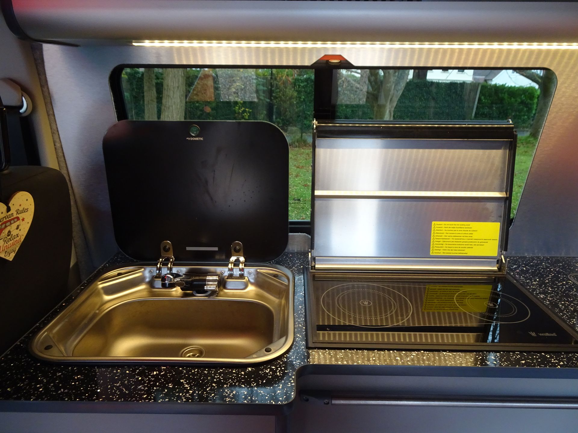 A kitchen with a sink and a stove top oven