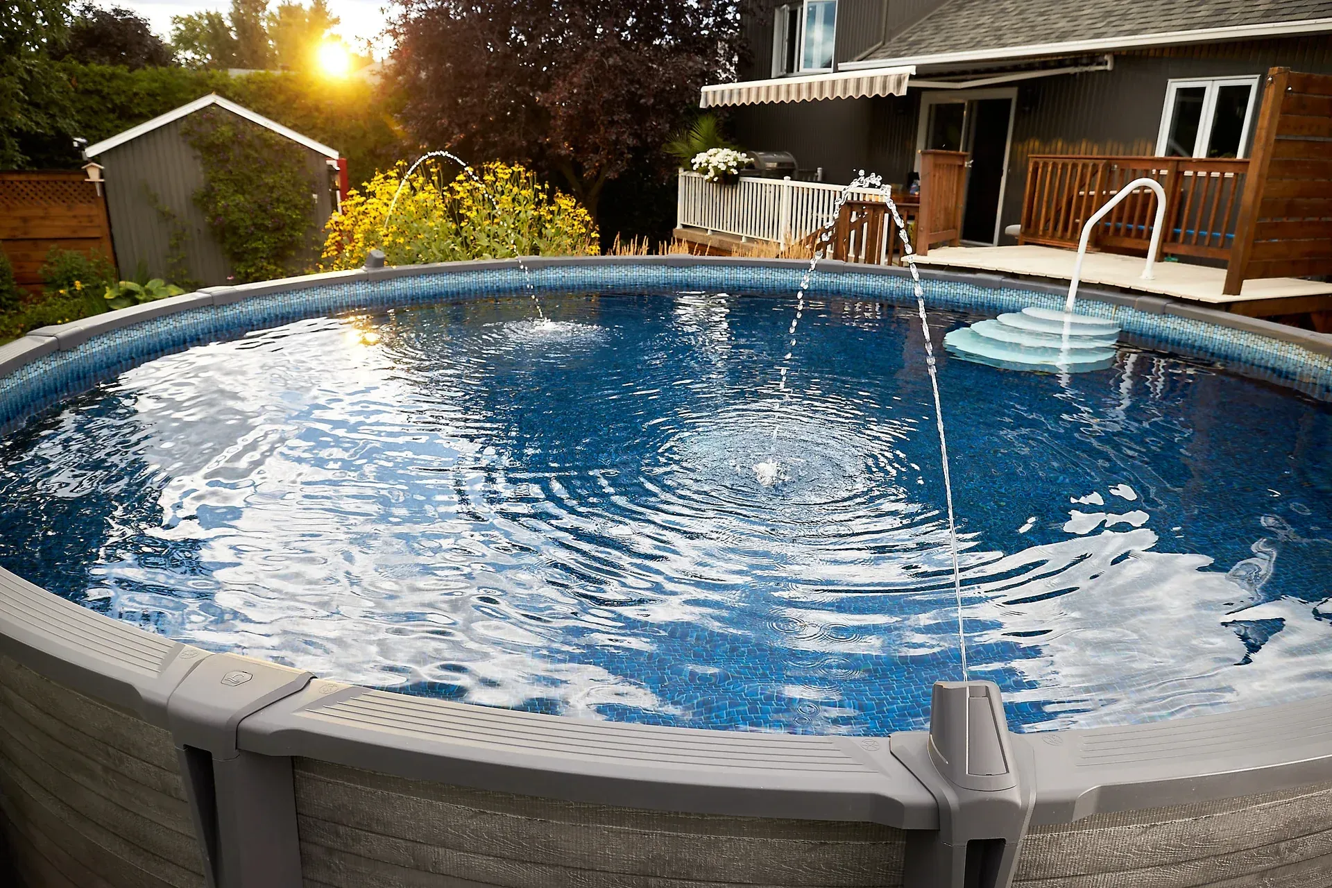 Screened-in backyard pool with blue water and wooden deck in sunlight