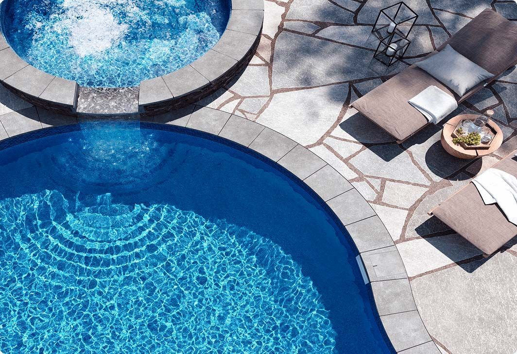 A large indoor swimming pool with a clear roof.