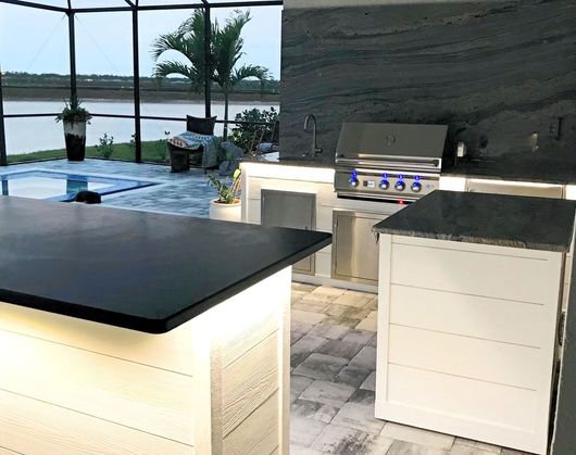 Luxury outdoor kitchen design with custom cabinetry and integrated grill for high-end Florida homes.