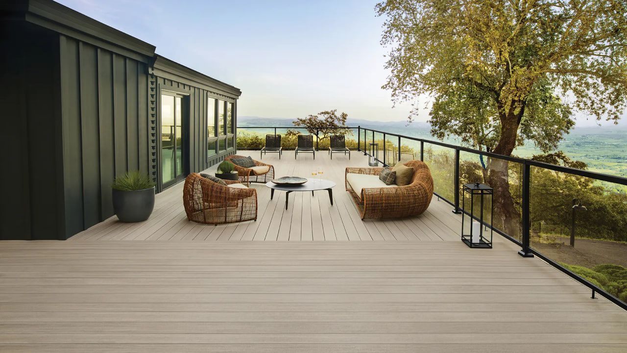 Screened-in backyard pool with blue water, wooden deck, and lounge chairs in the sun