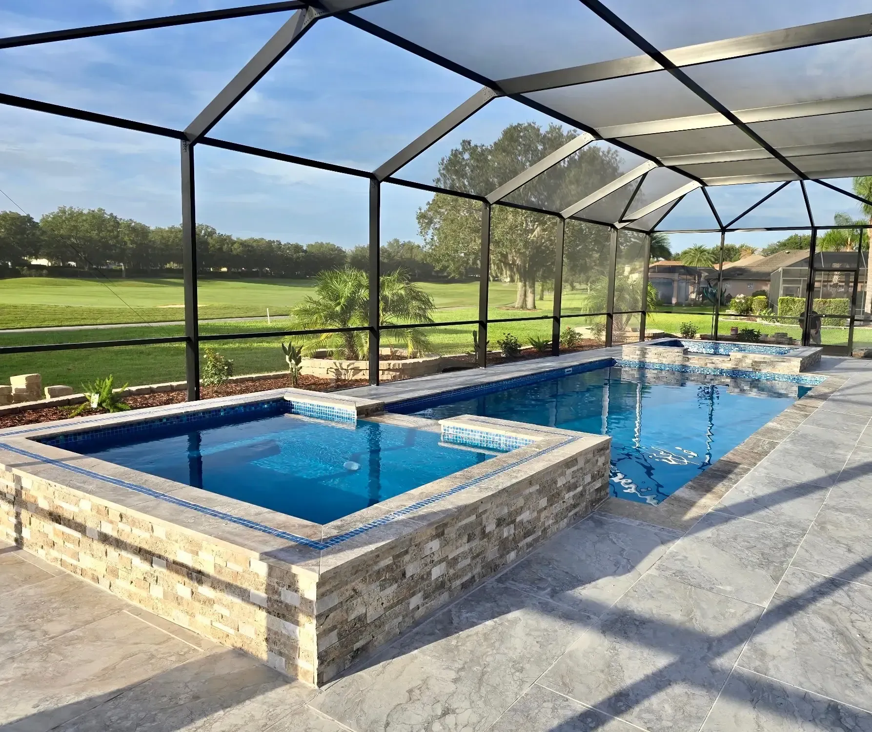 A large indoor swimming pool with a clear roof.