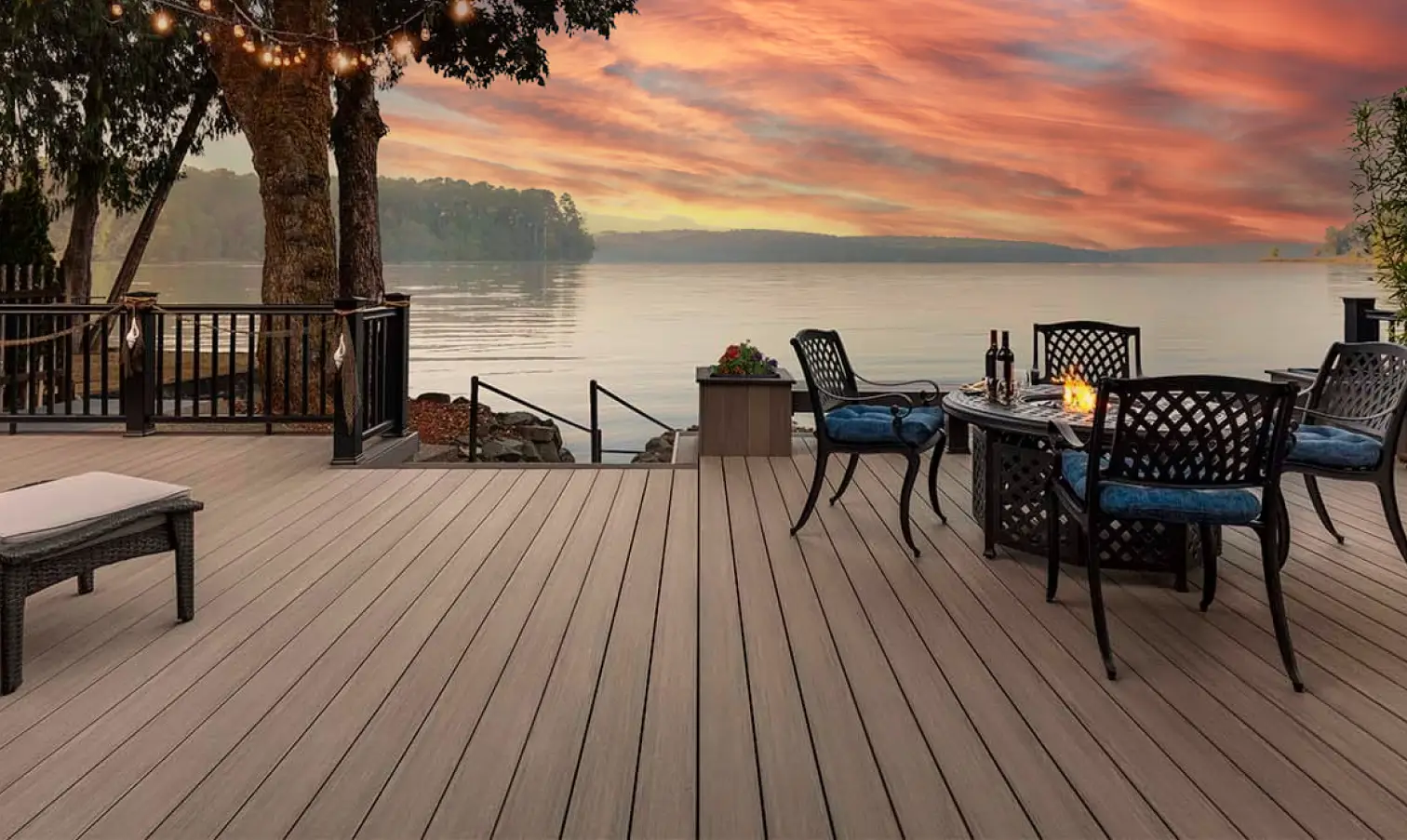 Screened pool deck with an above-ground pool wrapped with a wood deck and retaining wall for a sloped backyard