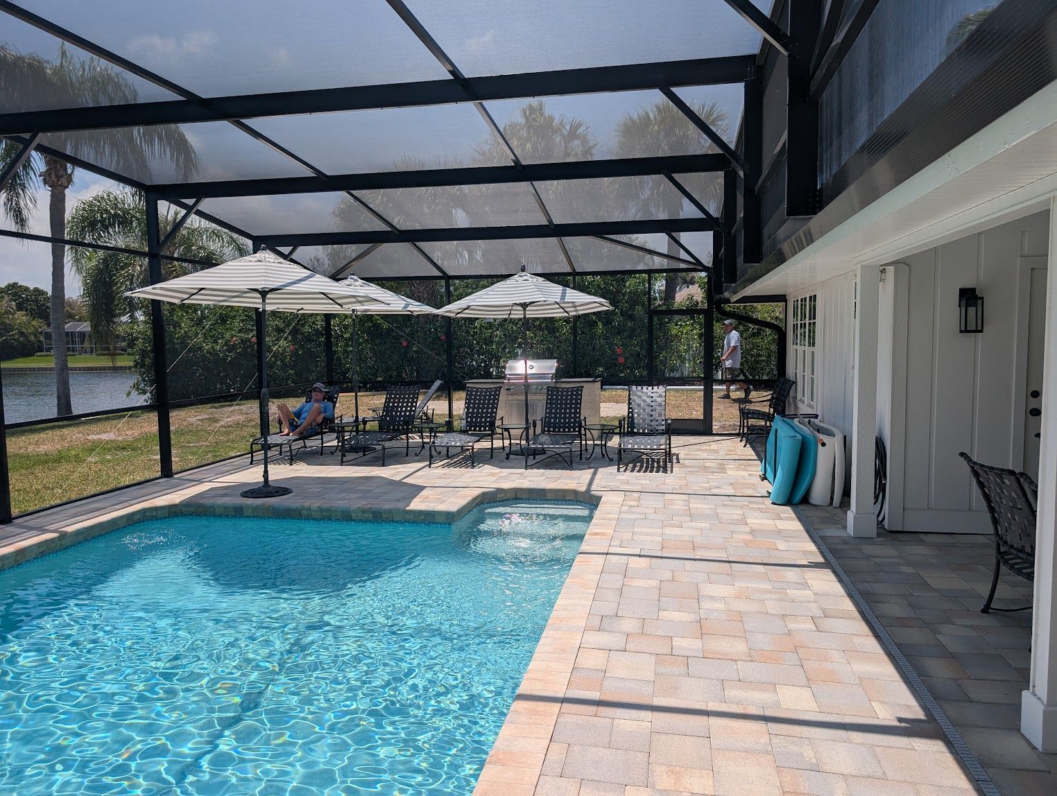 A large indoor swimming pool with a clear roof.