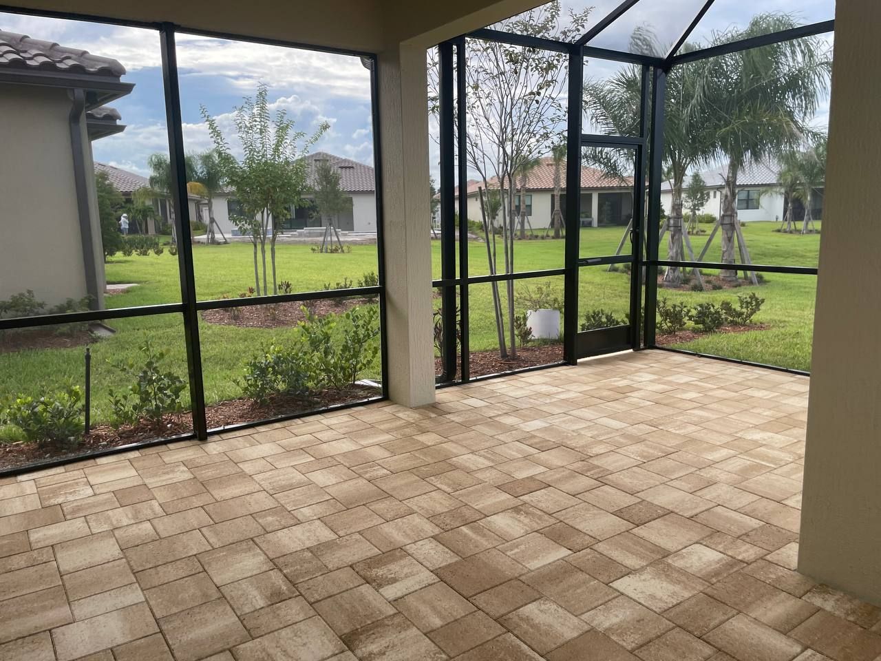 A before and after picture of a screened in porch with a broken gutter , door , downspout and screen.