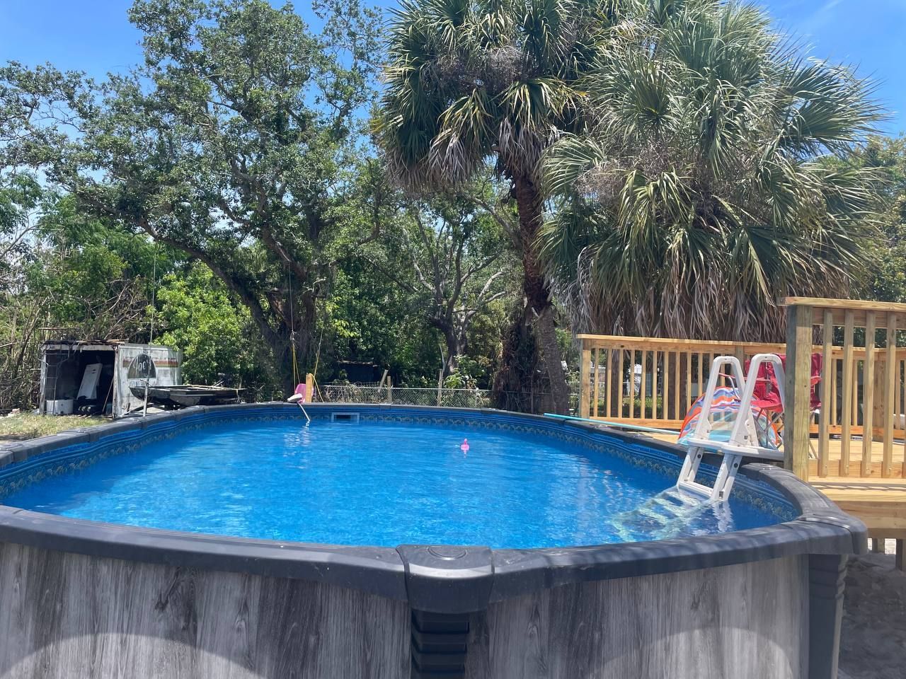 A large indoor swimming pool with a clear roof.