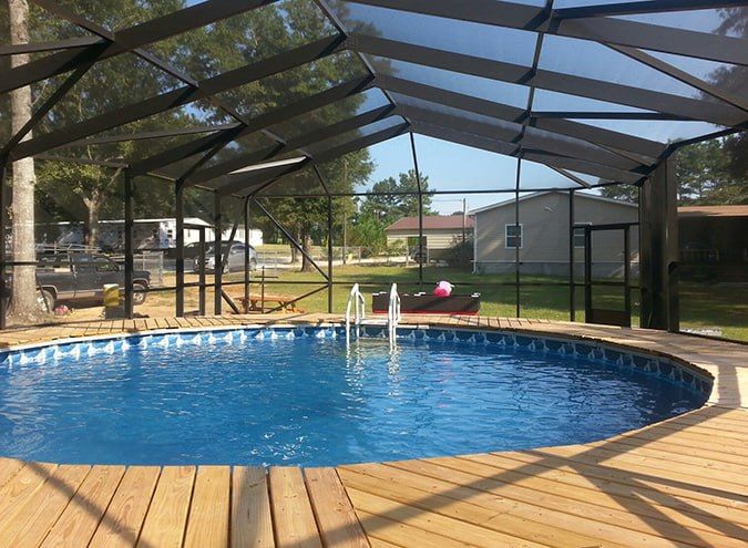 A large indoor swimming pool with a clear roof.
