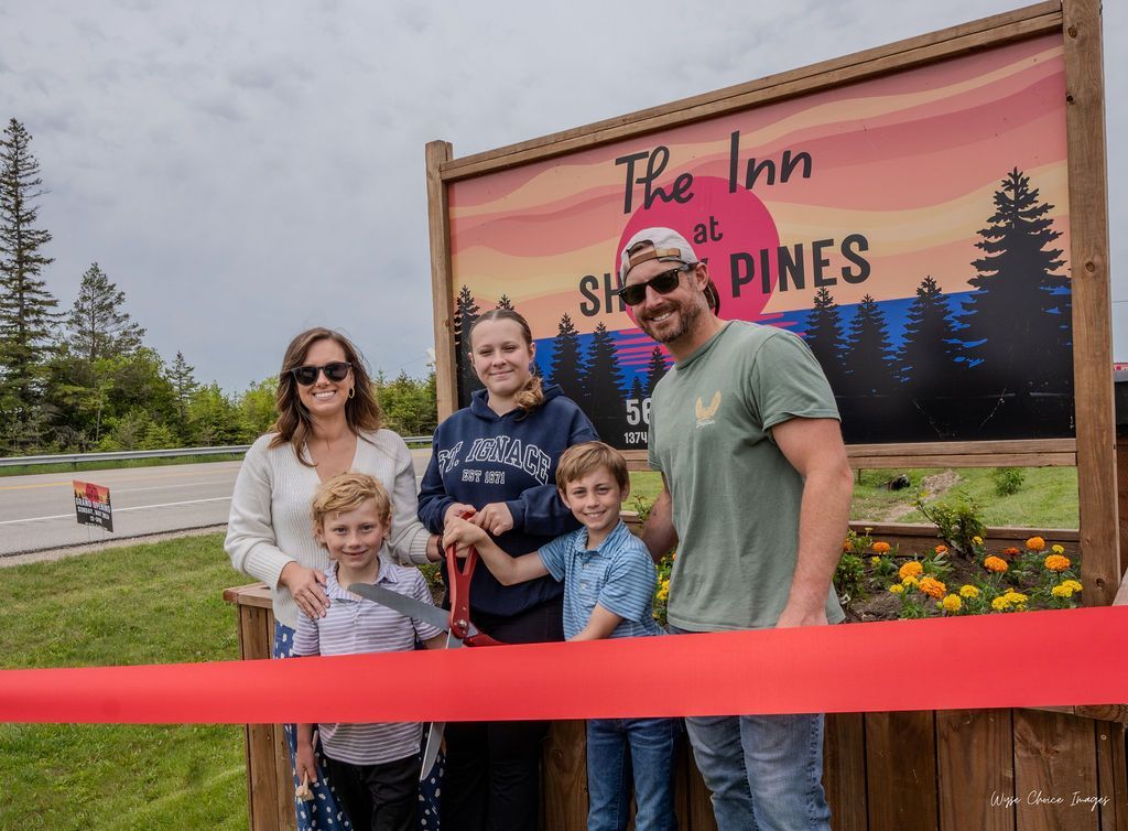 Ribbon cutting in front of a sign that reads 