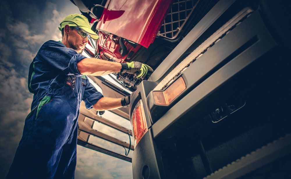 Mechanic Inspecting the Engine Bay of a Truck — BITR Enterprises in Southern Highlands, NSW