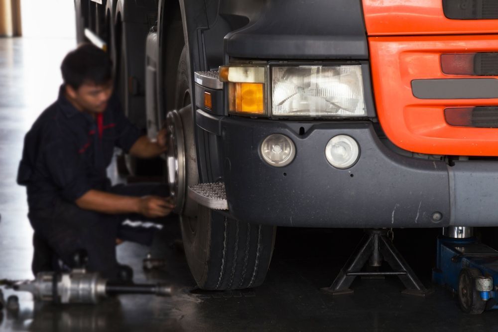 Truck Repairs Sydney Mechanic Servicing A Heavy-duty Truck In Workshop.