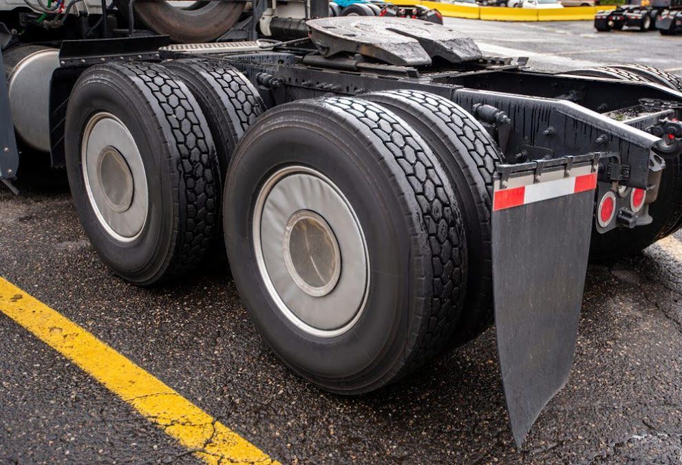 Rear View of a Truck’s Dual Tires and Mudflap on a Road — BITR Enterprises in Berkeley, NSW
