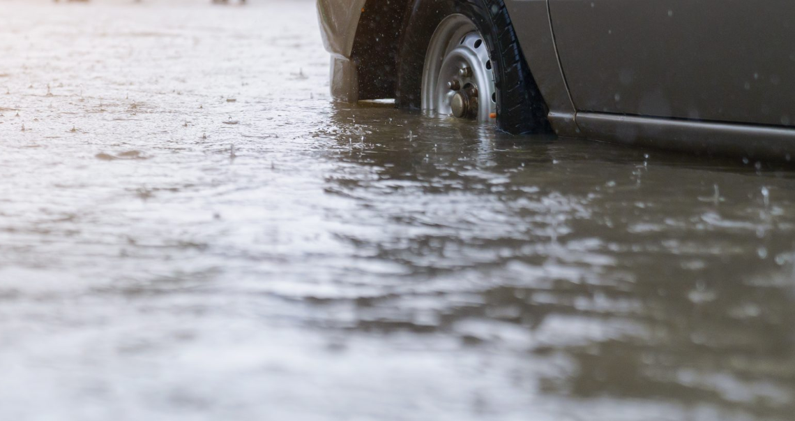 close up of flood rising around car