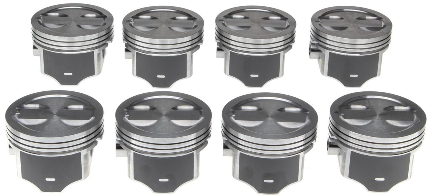 Eight gray metal pistons arranged in two rows on a white background