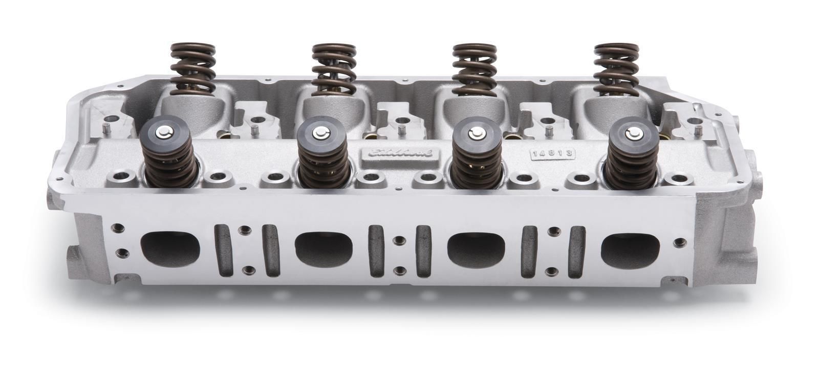 Silver engine cylinder head with four valves and visible valve springs on a white background
