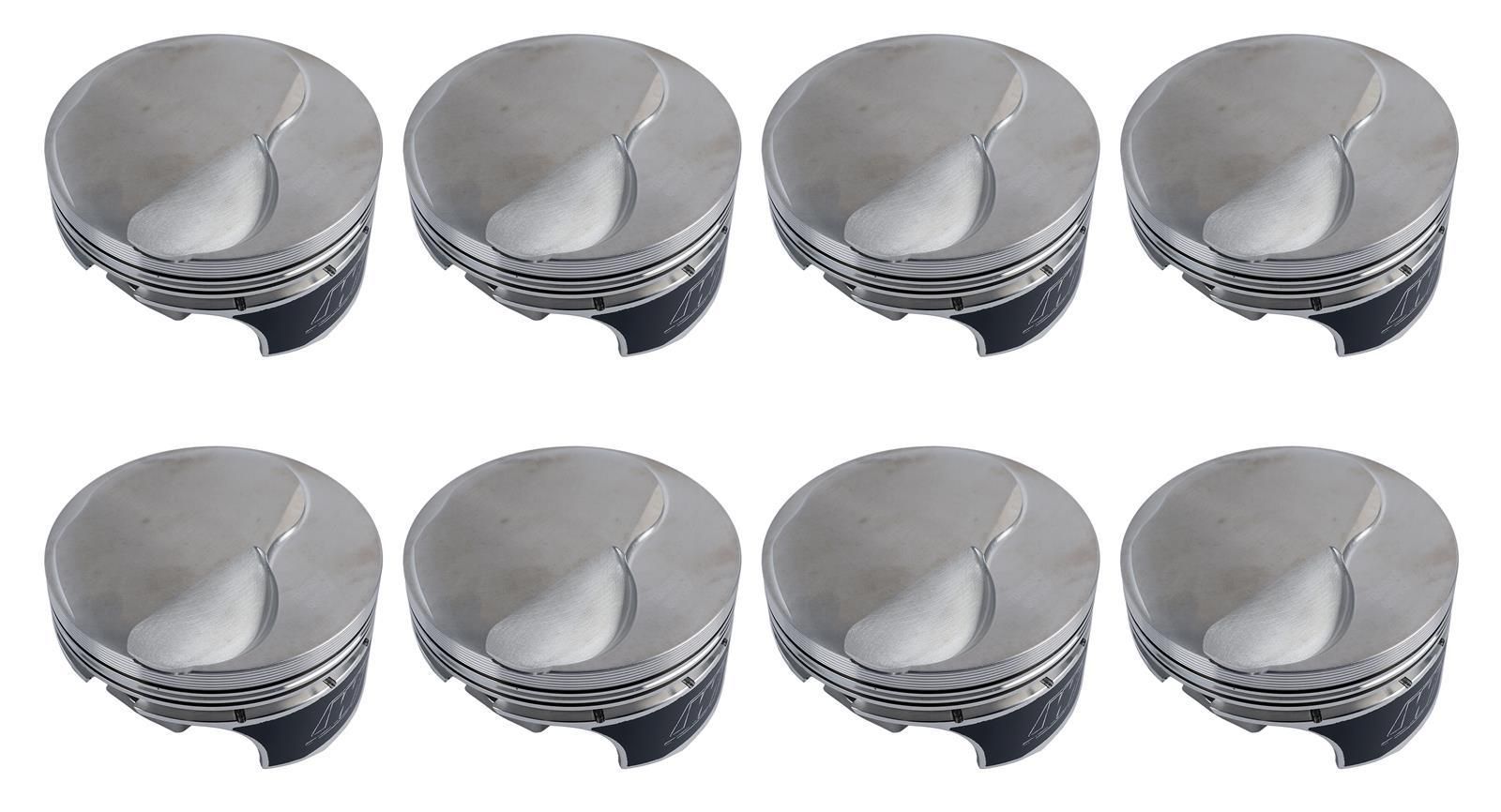 Eight silver metal piston tops arranged in two rows on a white background