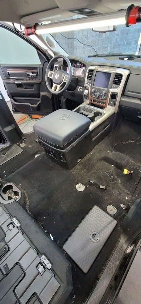 The interior of a dirty car is being cleaned.