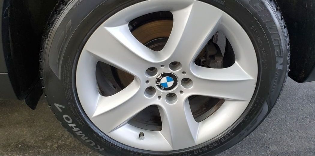 A close up of a bmw wheel with a tire on it.