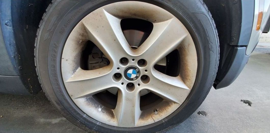 A close up of a bmw wheel with a tire on it.