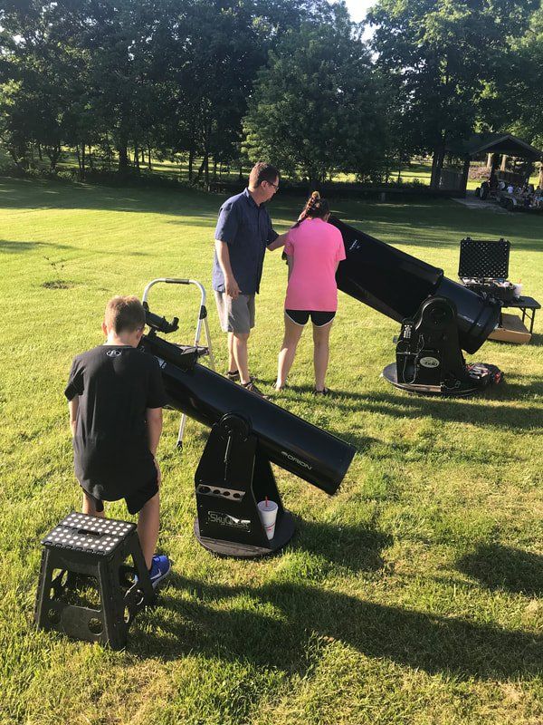 kids looking through telescopes