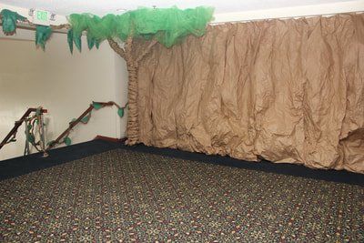 VBS room decoration of tree and rock wall