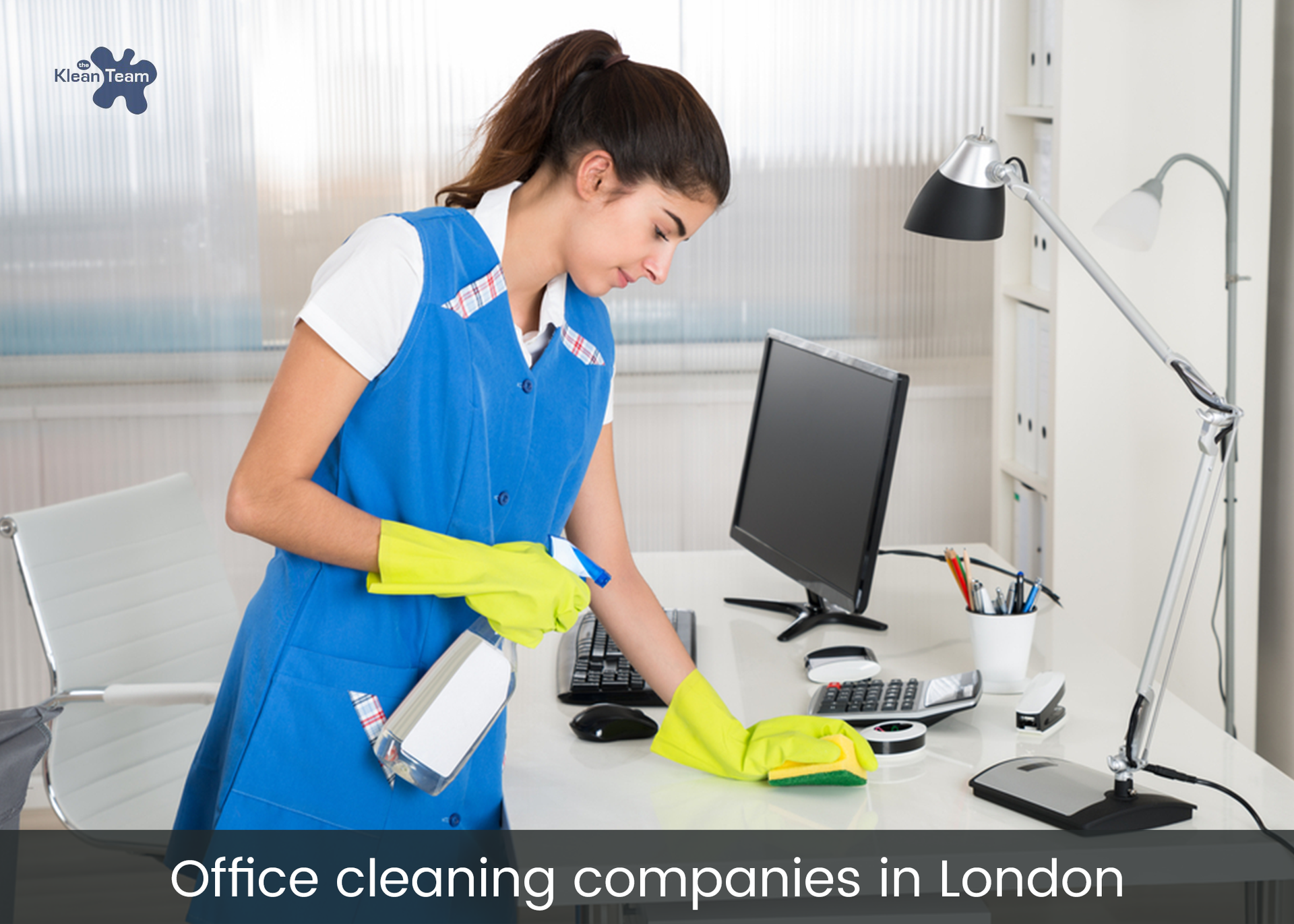 A woman is cleaning a desk in an office.