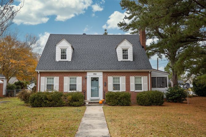 small brick home with green lawn