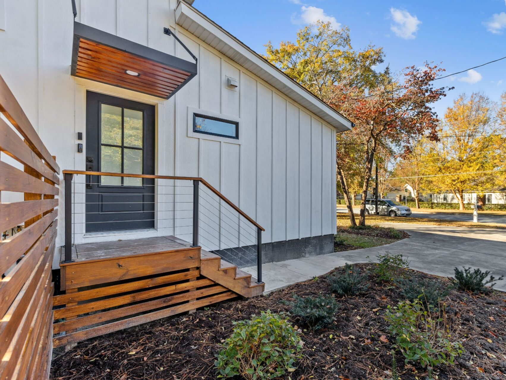 house with white siding and wooden steps