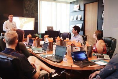 A man delivers workshop to corporate team members