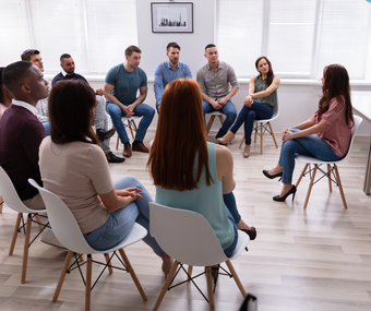 A female coaching hosting a group life coaching session in the Change Your World Wellness Centre