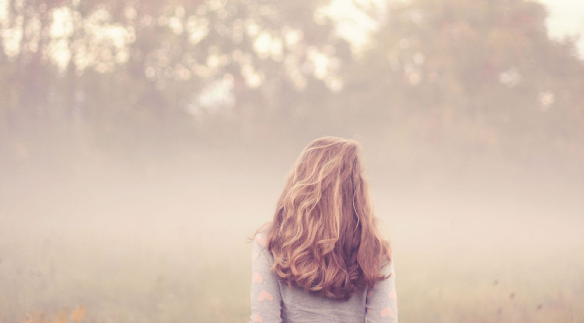 Woman looking into mist, reflecting on control, anxiety and learning to let go.