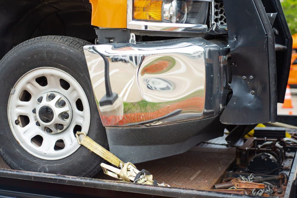 A Truck is Being Towed by a Tow Truck — Al's Panel Shop in Tennant Creek, NT