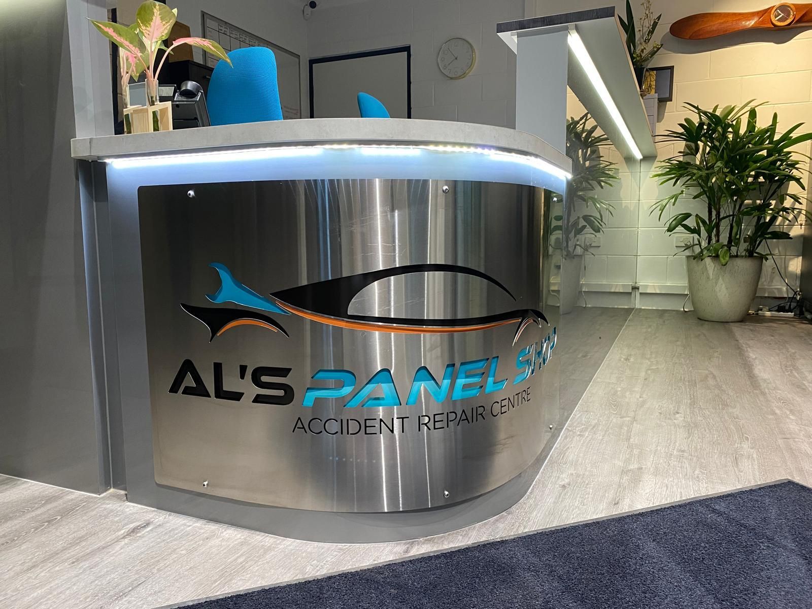 A sleek, curved metal reception desk for 