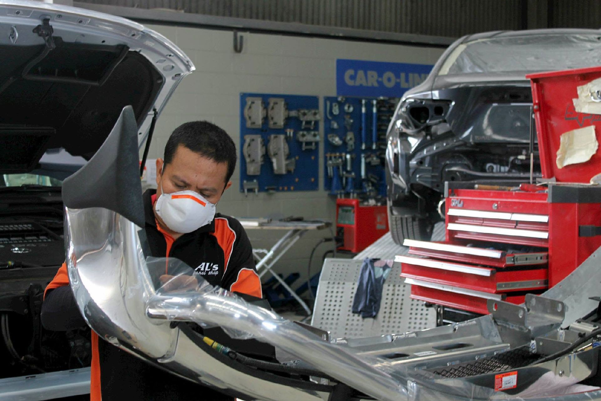 Panel Beater In Darwin Working On A Car