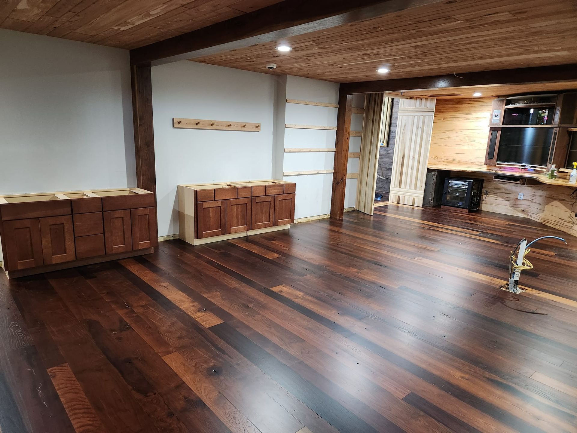 A room with wooden floors and cabinets in it