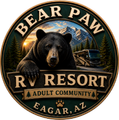 Bear Paw RV Resort logo with bear, mountains, sunset, and trailer in Eagar, AZ