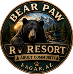 Bear Paw RV Resort logo with bear, mountains, sunset, and trailer in Eagar, AZ